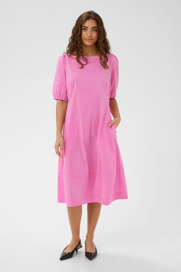 Woman wearing a pink dress on a white background